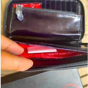 Brand new, Black Ed Hardy zip-around wallet ,box, and shiny new Leather inside.